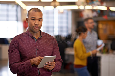 Buy stock photo Shot of a businessman using a digital tablet at work