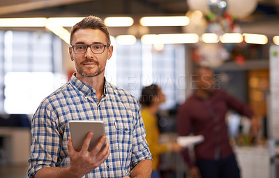 Buy stock photo Shot of a businessman using a digital tablet at work