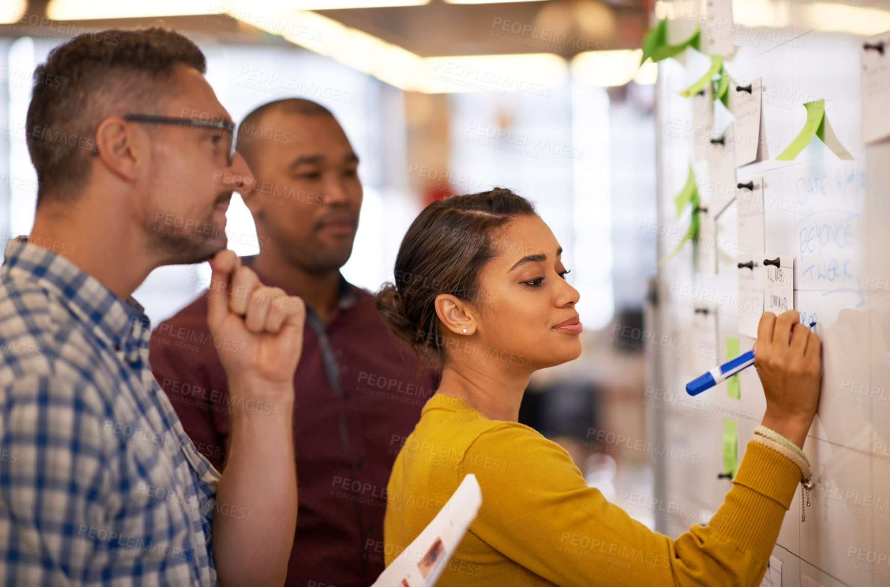 Buy stock photo Collaboration, whiteboard and a business woman writing during a meeting for coaching in the office. Teamwork, training and presentation with a young female employee teaching her colleagues at work