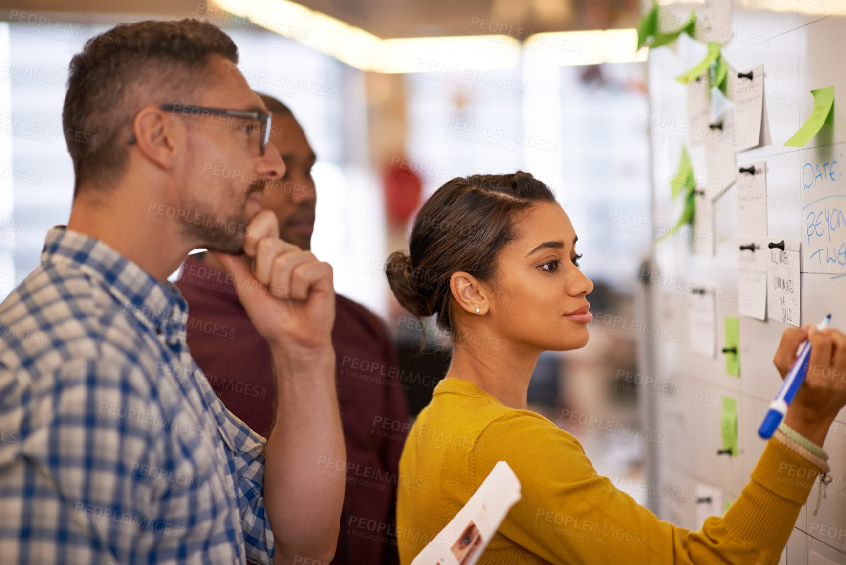 Buy stock photo Teamwork, whiteboard and a business woman writing during a meeting for coaching in the office. Collaboration, training and presentation with a young female employee teaching her colleagues at work