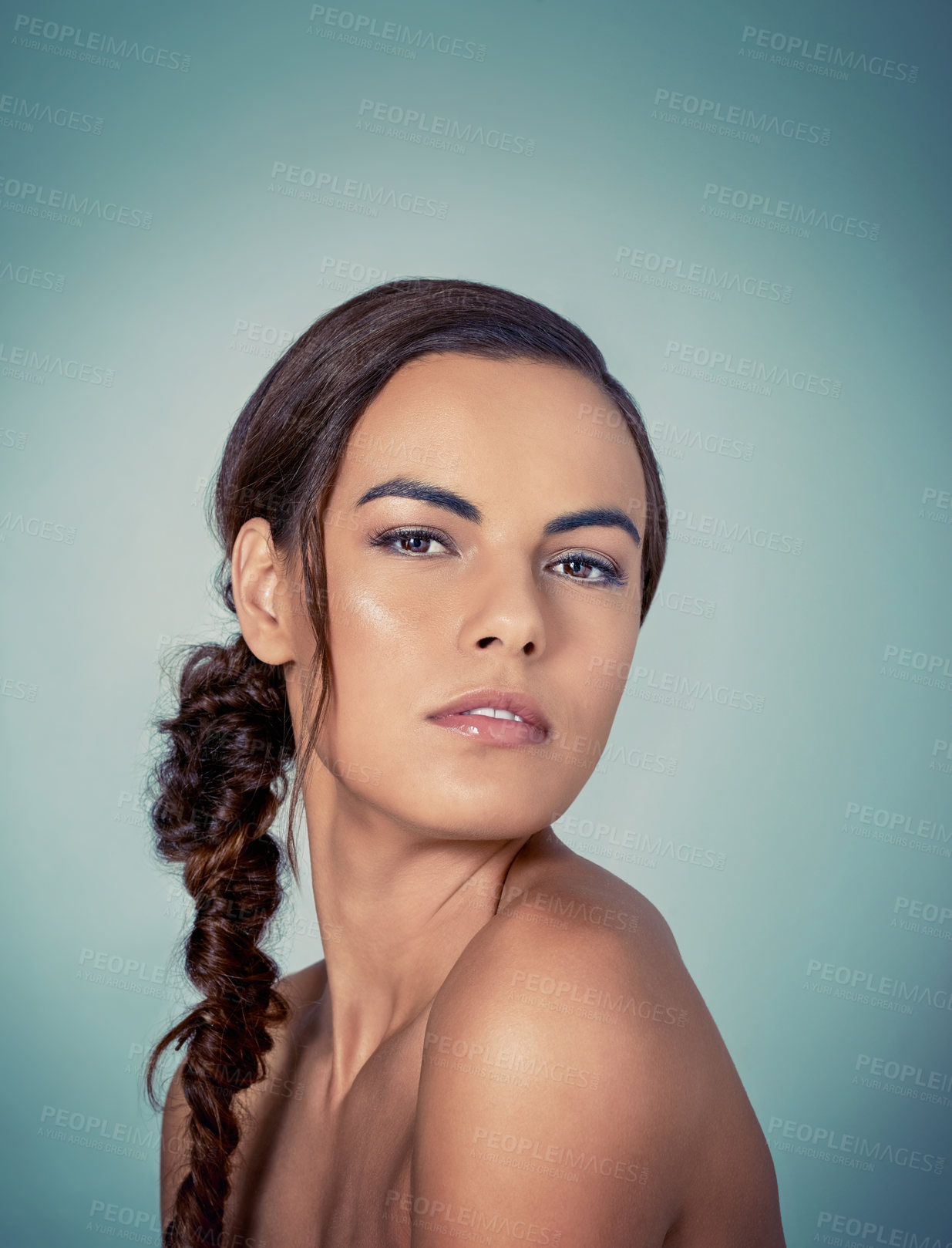 Buy stock photo Studio shot of a beautiful young woman posing against a green background