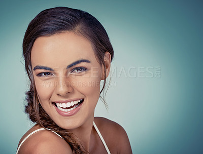Buy stock photo Studio shot of a beautiful young woman posing against a green background