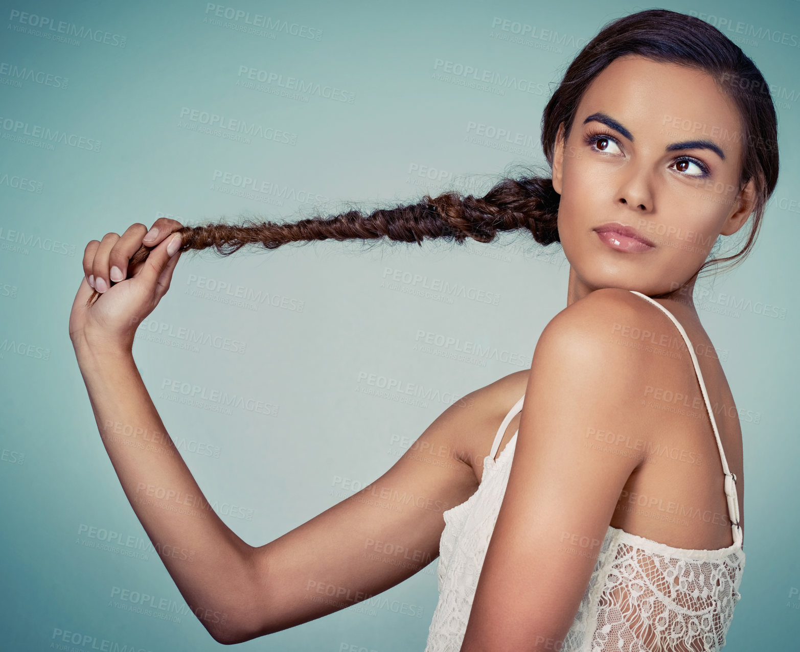 Buy stock photo Proud, studio and woman with hair, braid and person in mockup, haircare and showing of hairdo. Blue background, texture and confident in salon, shine and healthy hairstyle of model and cosmetics