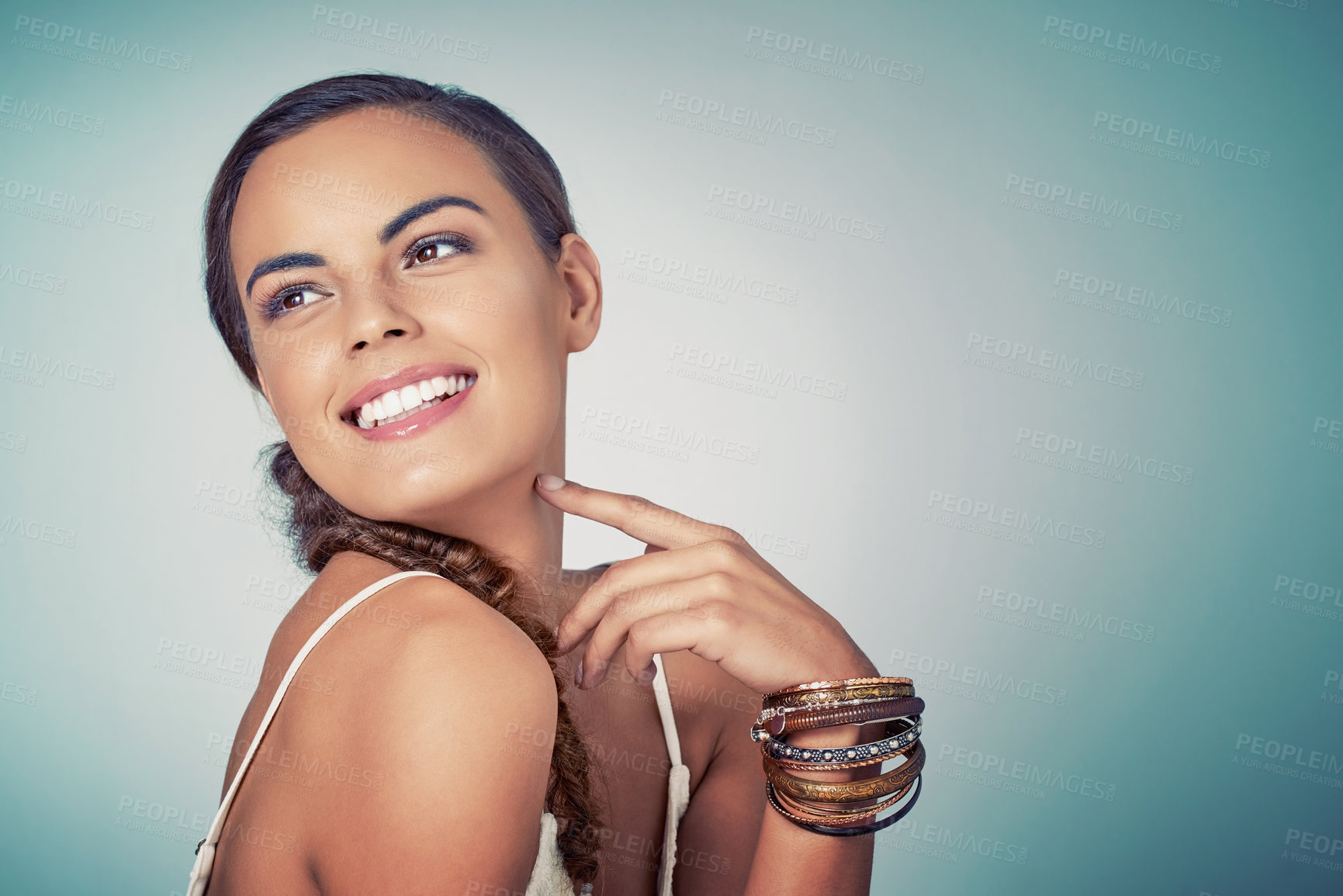 Buy stock photo Thinking, space or girl with beauty or skincare on blue background for shine, bangles or natural glow. Model, face or happy woman in studio for dermatology mockup, smooth results or facial health