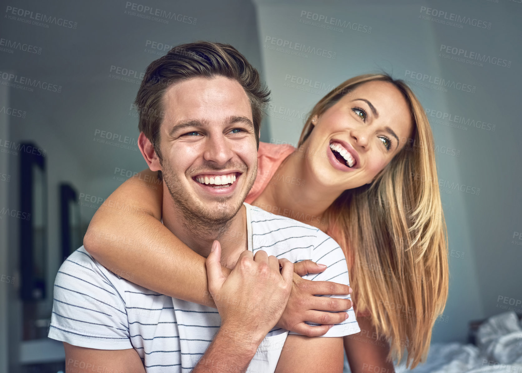 Buy stock photo Love, hug and happy couple laughing in bedroom or morning for fun romance, bonding or marriage. Smile, house rental or man with woman on break, honeymoon or staycation to relax on anniversary retreat