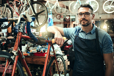 Buy stock photo Portrait of a mature man working in a bicycle repair shop