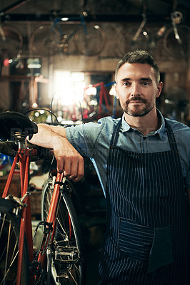 Buy stock photo Serious, portrait and repair man in bicycle shop working in store or cycling workshop. Face, bike mechanic and confident male person, business owner or mature professional technician from Australia.