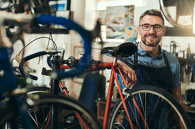 Buy stock photo Portrait, happy and repair man in bicycle shop for working in store, cycling workshop and startup. Confident bike mechanic, small business owner and mature male technician with glasses in Australia