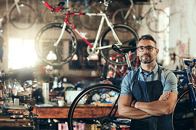 Buy stock photo Portrait, serious and repair man in bicycle shop with arms crossed working in workshop. Face, bike mechanic and confident male person, professional or mature technician with glasses in small business