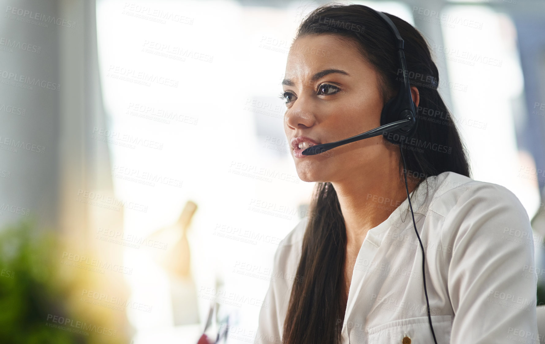 Buy stock photo Shot of a female agent working in a call centre