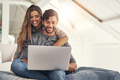 Buy stock photo Couple, laptop and relax or embrace on bed with online search for holiday destination or discount offers on travel. People, happy or hug in bedroom in home with bonding, social media browsing or love