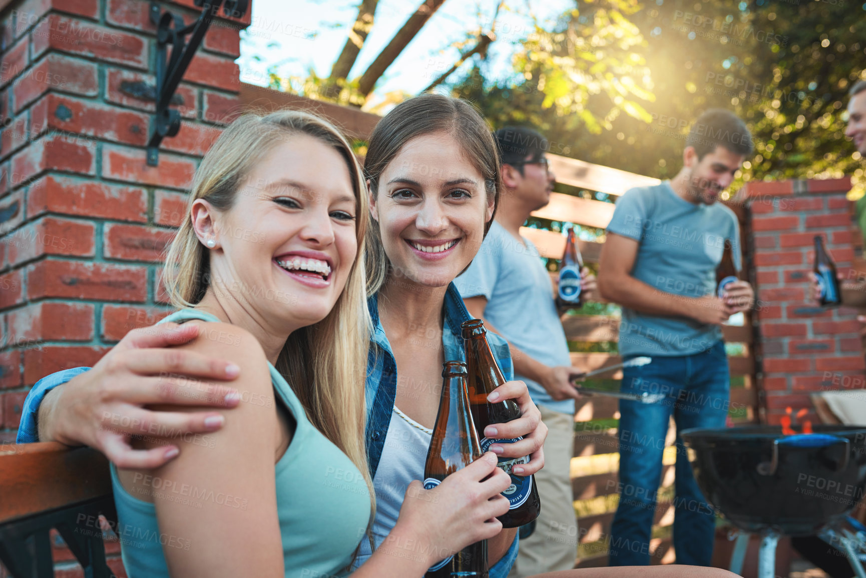 Buy stock photo Friends, portrait and beer hug in outdoor, bonding and laughing together at labour day barbecue. People, happiness and embrace in backyard of home for fun, alcohol bottles and funny joke or humor