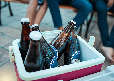 Buy stock photo Shot of bottled beers chilling in a cooler box at an outdoor gathering