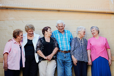 Buy stock photo Shot of a group of seniors standing against a wall outside