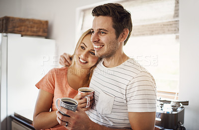 Buy stock photo Shot of a happy young couple enjoying coffee together in the morning at home