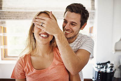 Buy stock photo Shot of a young man playfully covering his girlfriend’s eyes at home