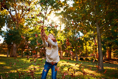 Buy stock photo Girl, child and leaves or catch in park for adventure, fun activity and autumn game with enjoyment outdoor. Kid, happy and excited with freedom, holiday or wellness on grass in nature with sunlight