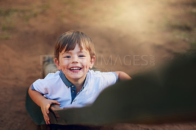 Buy stock photo High angle shot of a happy little boy climbing a ladder in a playground
