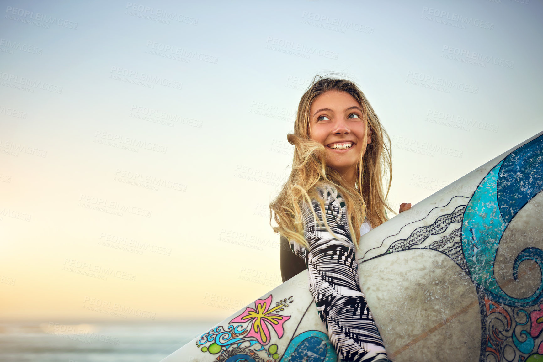 Buy stock photo Cropped shot of an attractive young female surfer standing with her surfboard on the beach