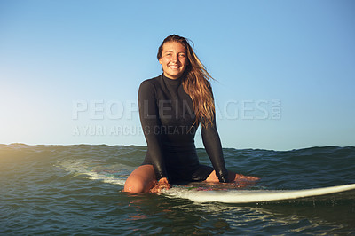 Buy stock photo Full length portrait of an attractive young woman sitting on surfboard in the ocean