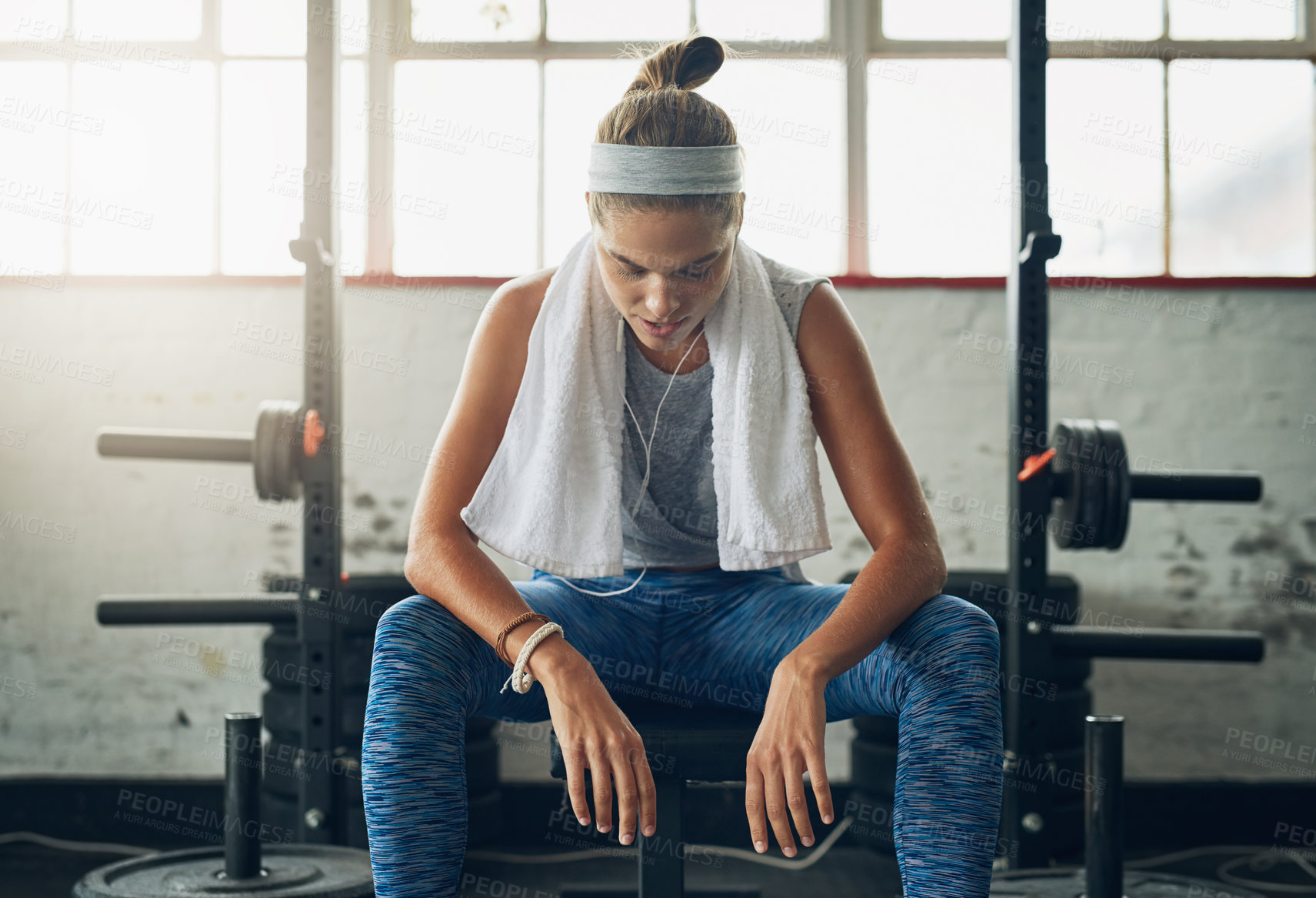 Buy stock photo Shot of a young attractive woman resting in a gym