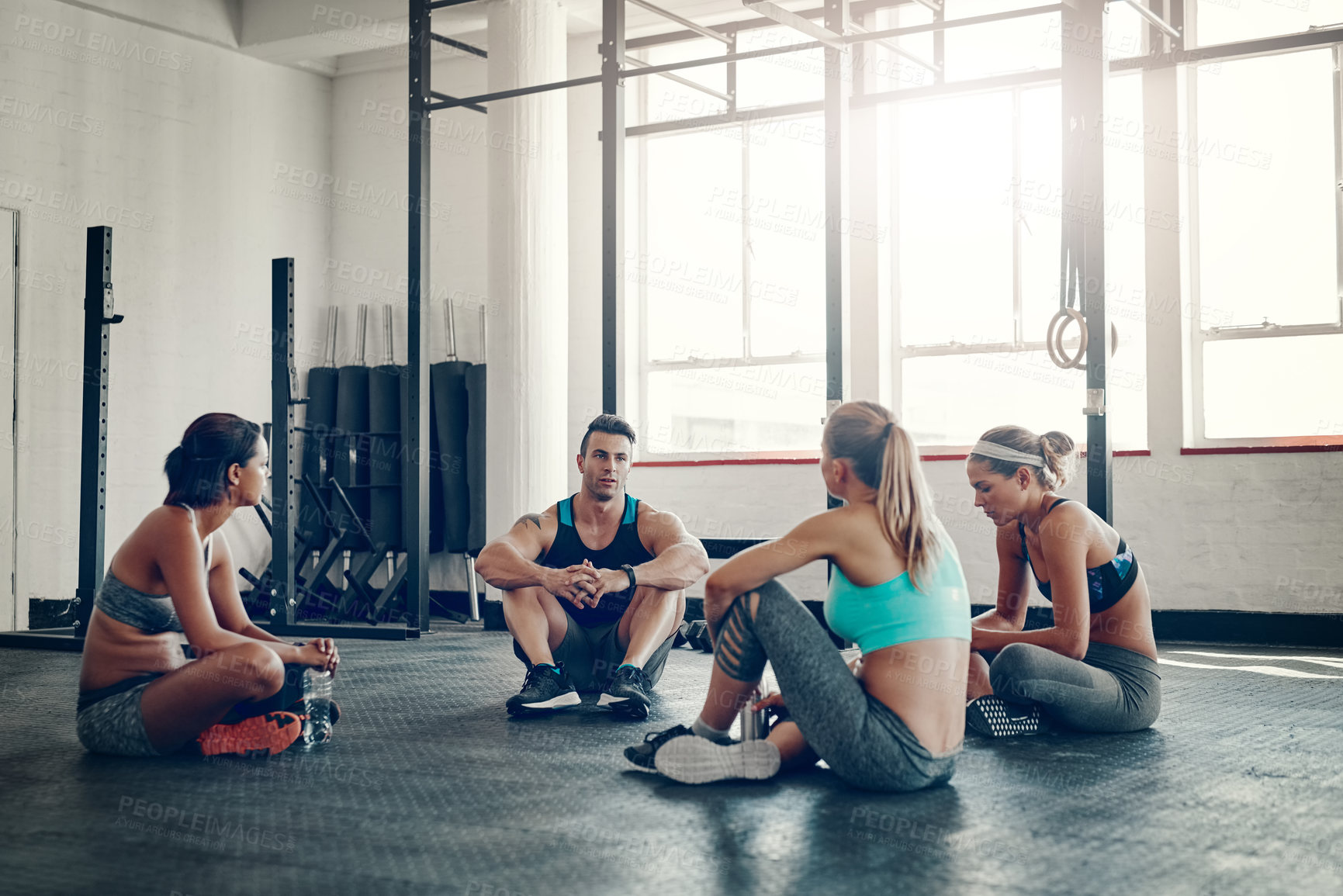 Buy stock photo People, fitness and discussion with team for meeting, workout routine or social on gym floor. Active group in conversation, rest or break after indoor training or exercise together at health club