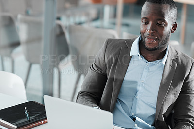 Buy stock photo Cropped shot of a young businessman working at his desk