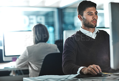 Buy stock photo Cropped shot of a young businessman working on his computer at his desk