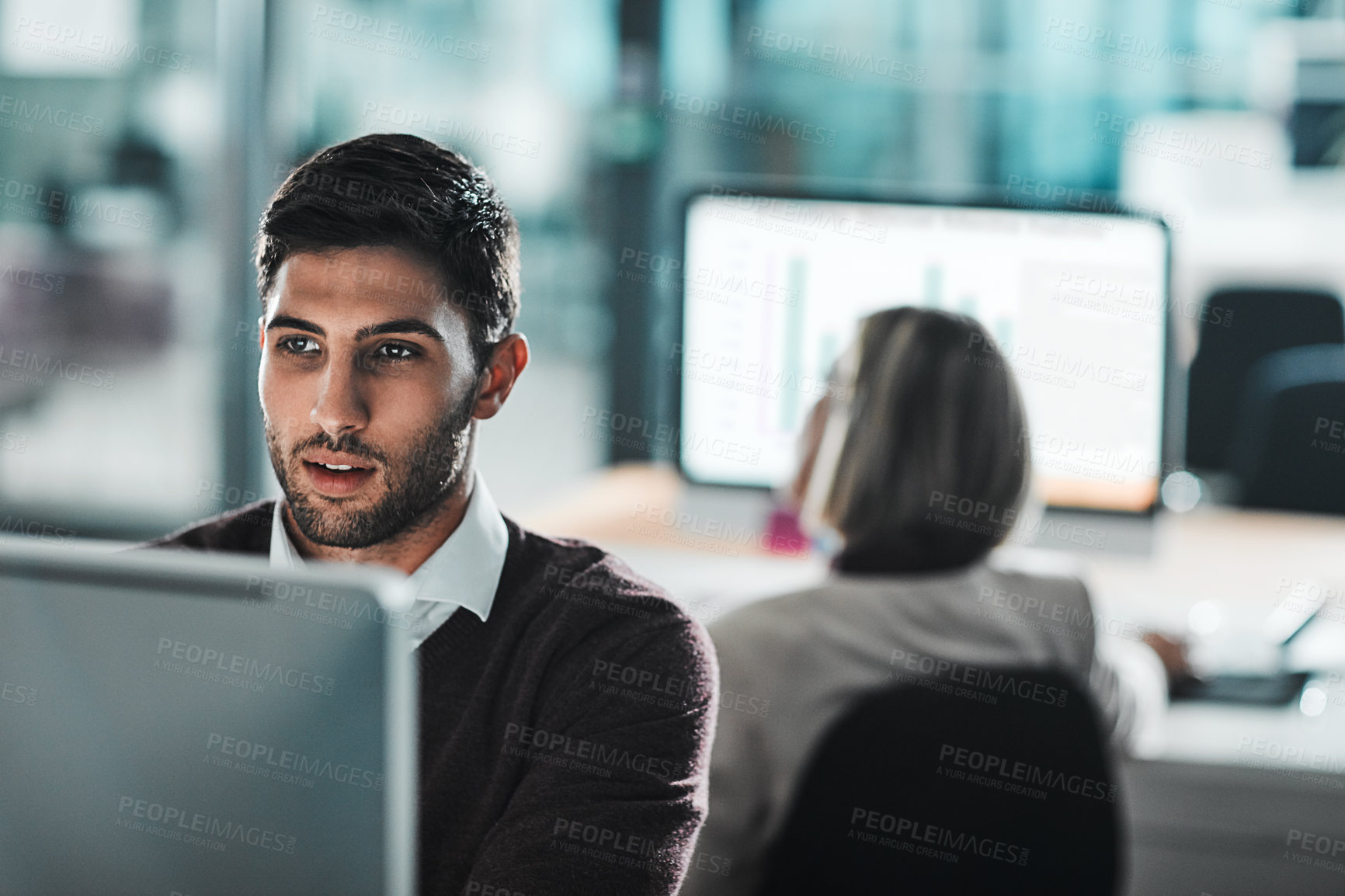 Buy stock photo Cropped shot of a young businessman working on his computer at his desk