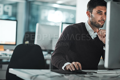 Buy stock photo Cropped shot of a young businessman working on his computer at his desk