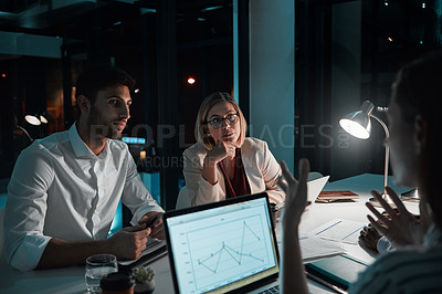 Buy stock photo Employee, teamwork and laptop in office at night with documents for deadline or overtime as accountant. People, partnership and feedback or explain for financial reviews, records and graph on screen