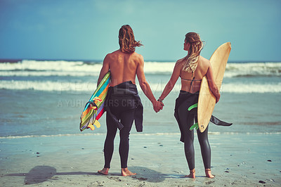 Buy stock photo Rearview shot of a young couple waiting for the perfect wave