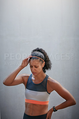 Buy stock photo High angle shot of an attractive young woman looking exhausted after a run