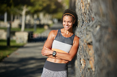 Buy stock photo Cropped shot of an attractive young woman taking a break from her morning run