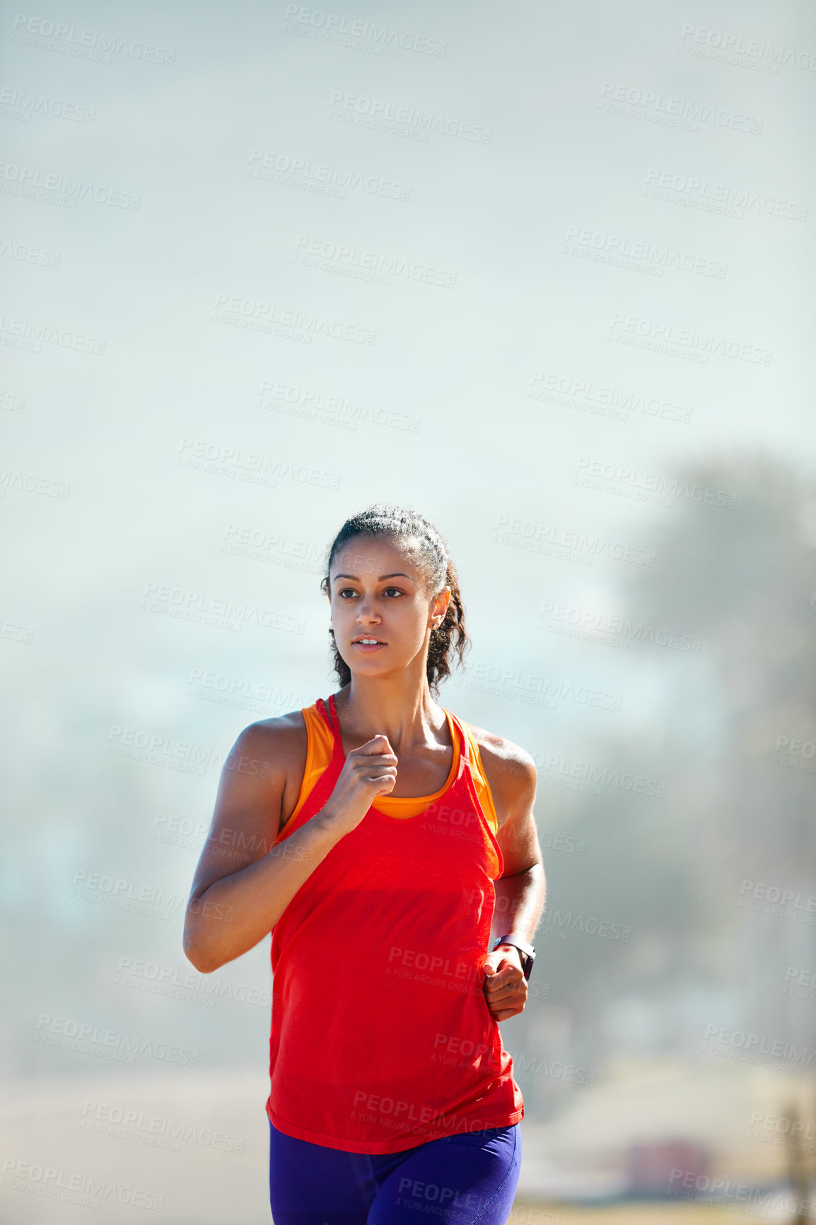 Buy stock photo Shot of a sporty young woman out for her morning run