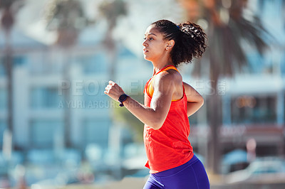 Buy stock photo Shot of a sporty young woman out for her morning run