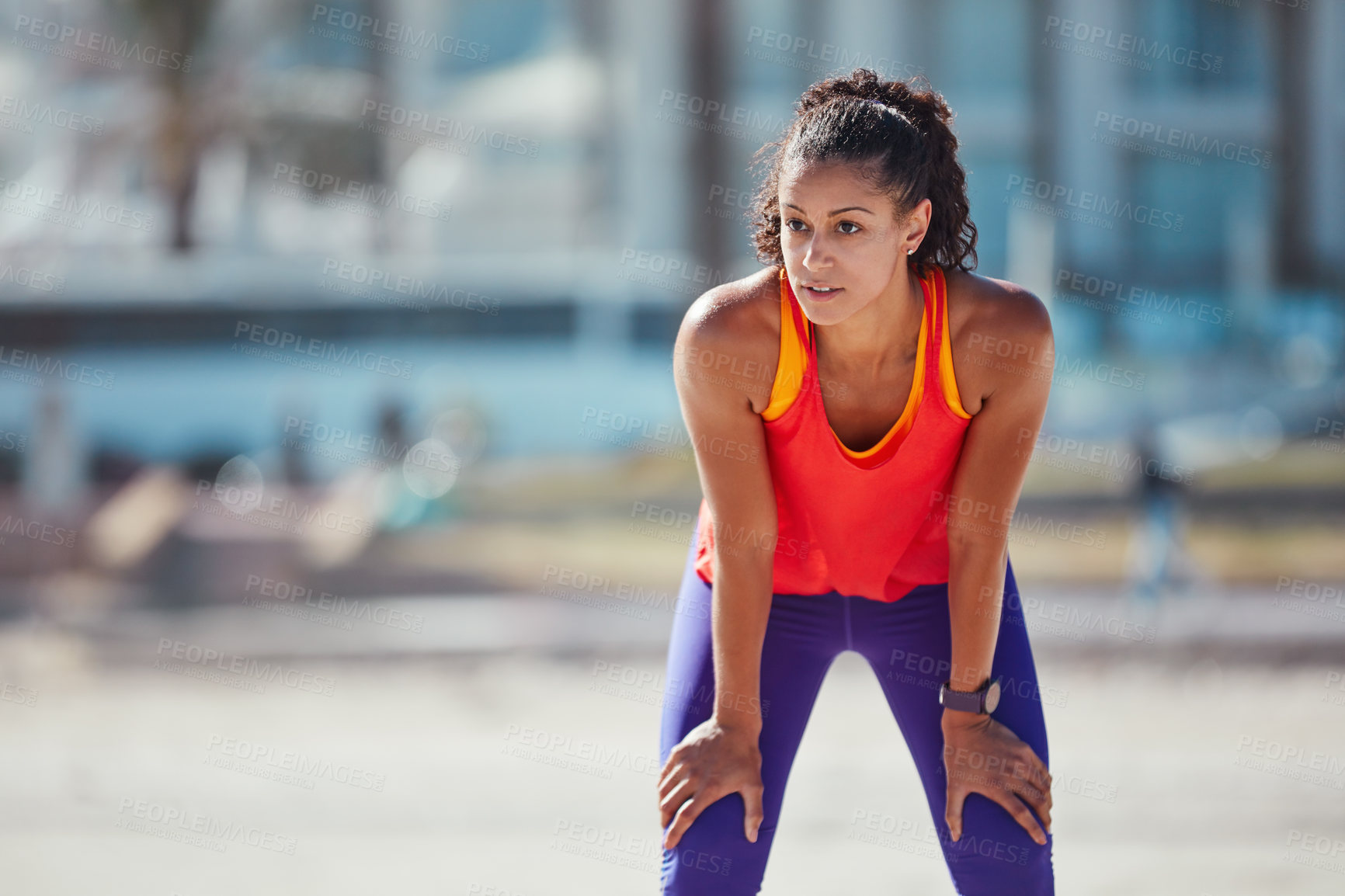 Buy stock photo Shot of a sporty young woman taking a break after an intense workout