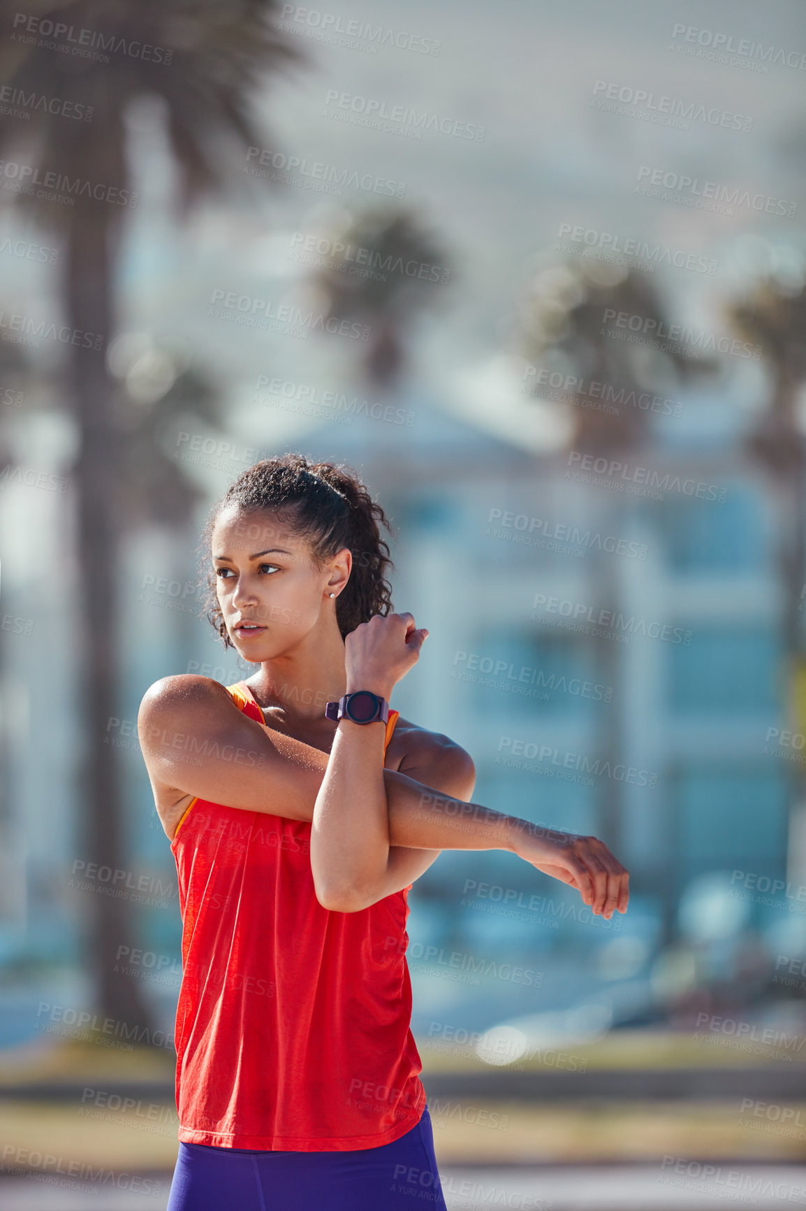 Buy stock photo Shot of a sporty young woman practising her exercise routine