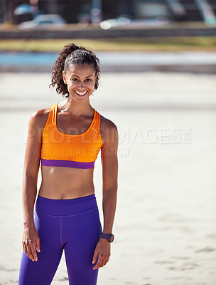 Buy stock photo Shot of a sporty young woman standing outside after her morning workout