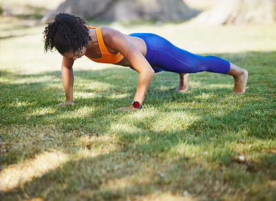 Buy stock photo Shot of a sporty young woman doing push ups as part of her exercise routine