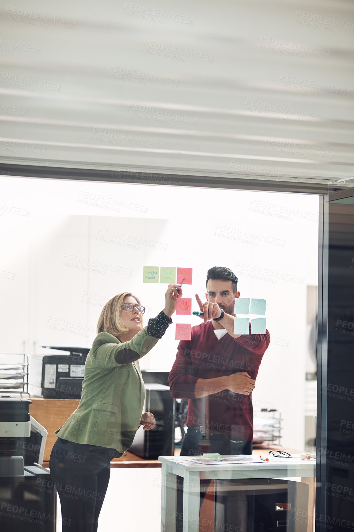 Buy stock photo Business people, planning or sticky note on glass in office, creative or teamwork for meeting. Man, woman and startup with writing for job on wall, entrepreneurs with research or brainstorming