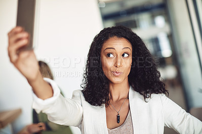 Buy stock photo Shot of a young businesswoman taking a selfie in the office