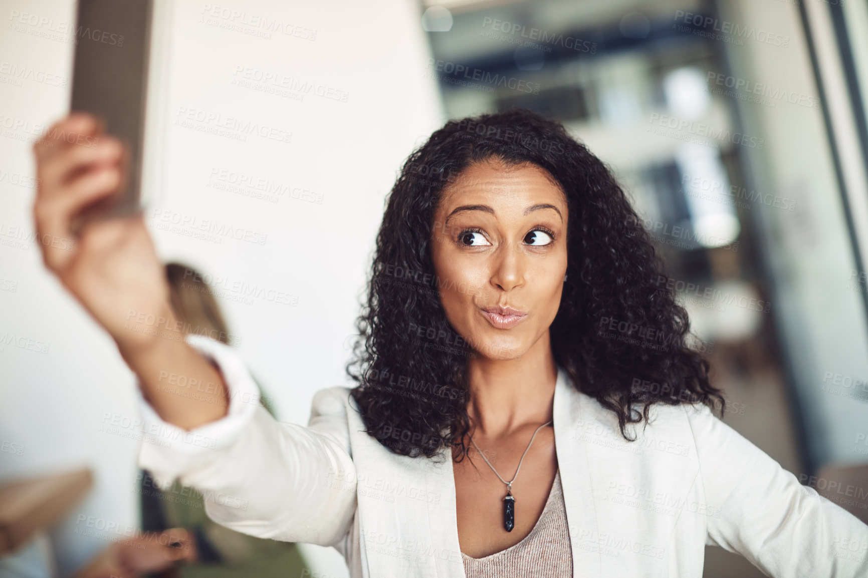 Buy stock photo Shot of a young businesswoman taking a selfie in the office