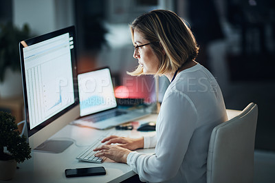 Buy stock photo Shot of a businesswoman using a computer during a late night at work