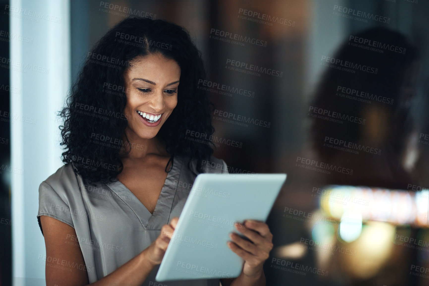 Buy stock photo Employee, night and woman with tablet, typing and internet with connection, social media or website info. African person, agent or consultant with tech, evening or scrolling for text message or smile