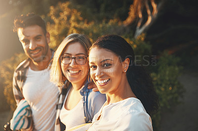 Buy stock photo Cropped shot of three friends enjoying themselves while spending the day outdoors