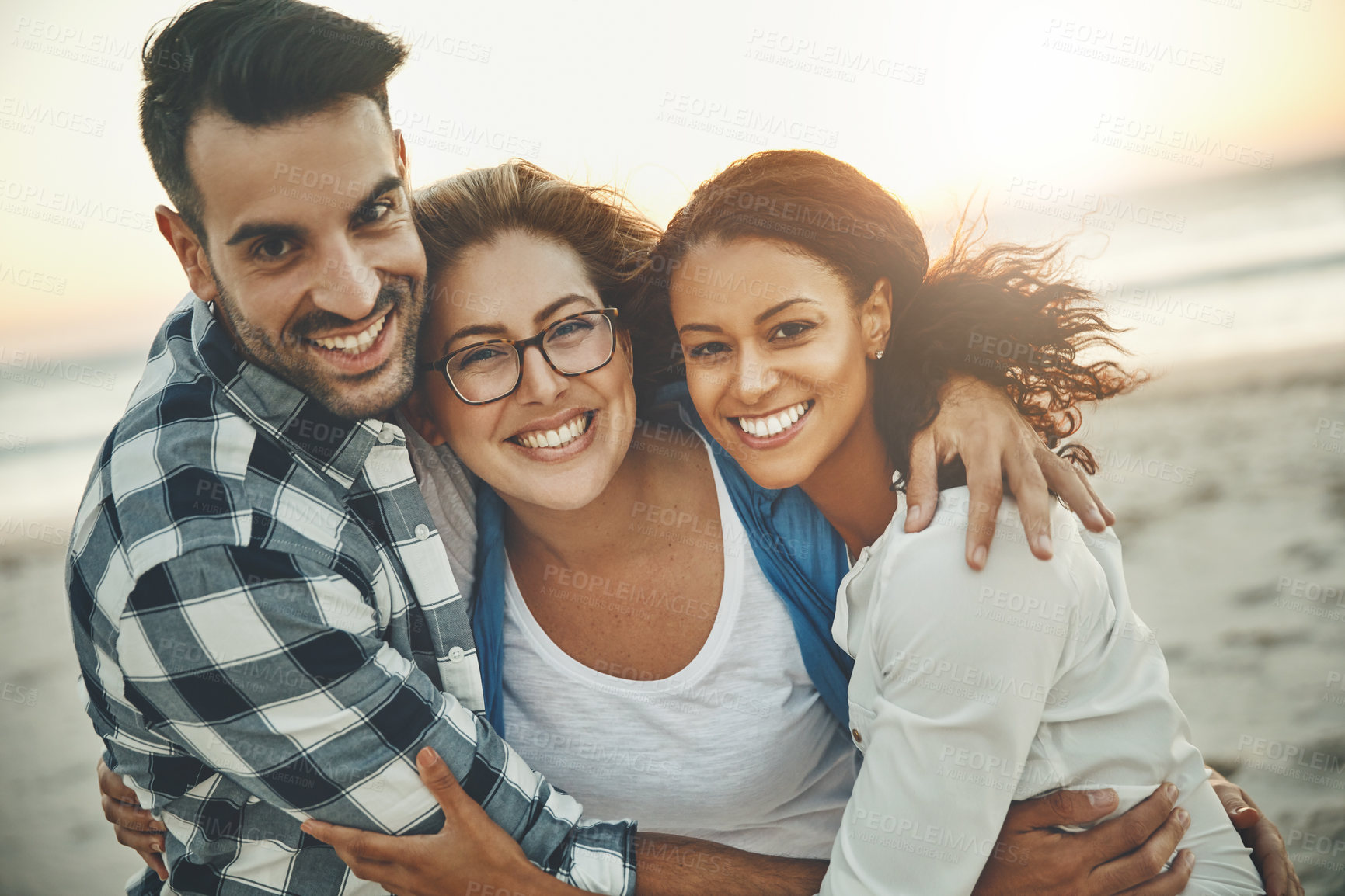 Buy stock photo Cropped shot of three friends enjoying themselves while spending the day outdoors