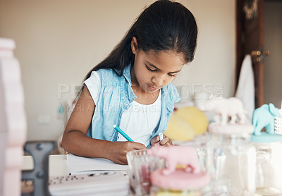 Buy stock photo Shot of a cute young girl drawing on paper at home