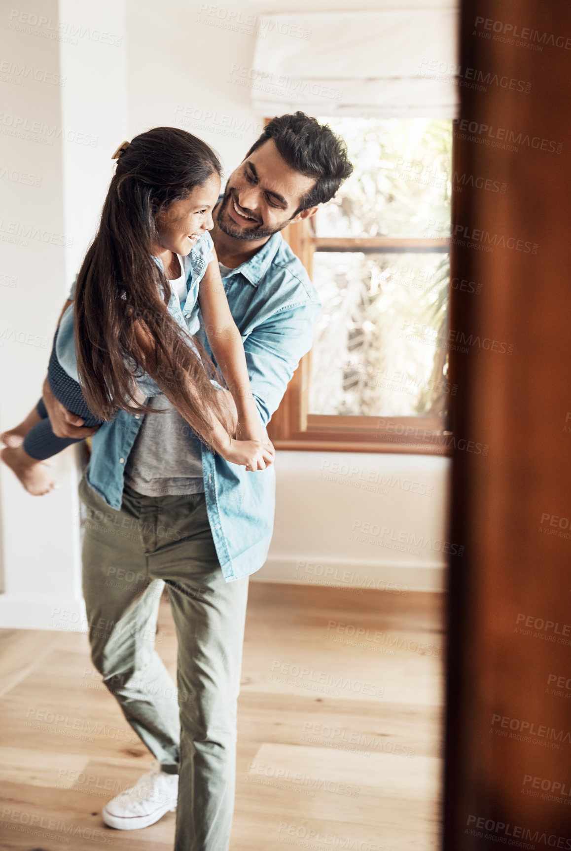 Buy stock photo Father, play and child in air with laughing, love and bonding together in family home with smile. Morning, man and airplane game with care, funny and young girl with fun and flying in lounge 