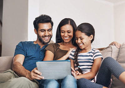 Buy stock photo Relax, smile and family on a sofa, tablet and bonding at home, connection and streaming a movie. Parents, mother and father on a couch, games and female child in the living room with cartoon film